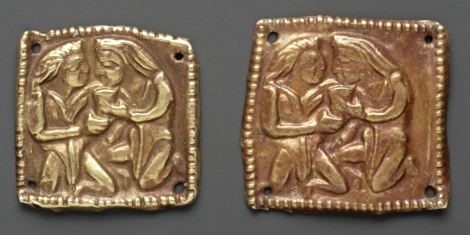 Two plaques, each showing two Scythians kneeling clasping a drinking vessel between them