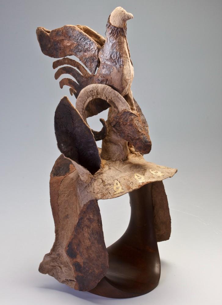 Metal headgear with figure of bird on top